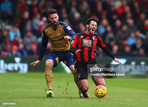 Adam Smith of Bournemouth is challenged by Olivier Giroud of Arsenal during the Barclays Premier League match between A.F.C. Bournemouth and Arsenal...