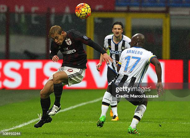 Keisuke Honda of AC Milan competes for the ball with Pablo Armero of Udinese Calcio during the Serie A match between AC Milan and Udinese Calcio at...