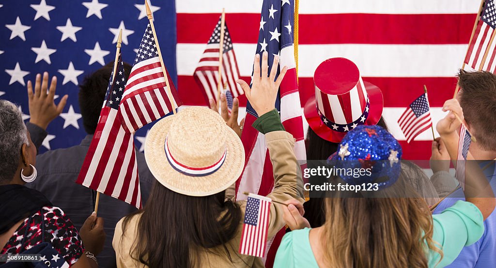 American people wave flags at political rally. USA.