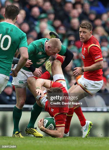 Liam Williams of Wales is dumped by Keith Earls of Ireland during the RBS Six Nations match between Ireland and Wales at the Aviva Stadium on...