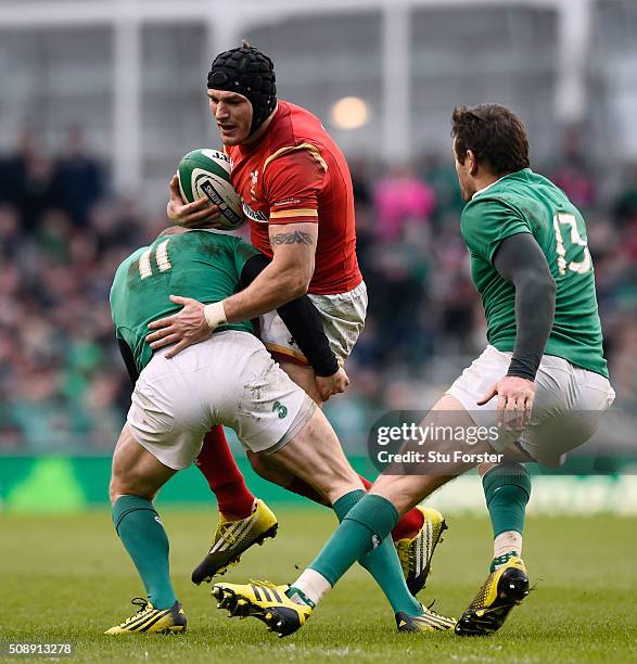 Tom James of Wales is tackled by Keith Earls of Ireland during the RBS Six Nations match between Ireland and Wales at the Aviva Stadium on February...