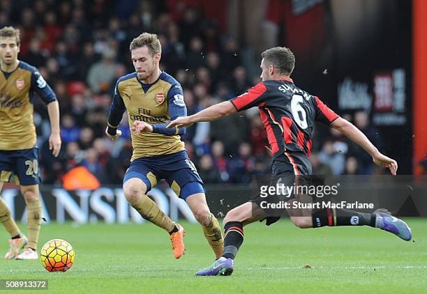 Aaron Ramsey of Arsenal breaks past Andrew Surman of Bournemouth during the Barclays Premier League match between AFC Bournemouth and Arsenal at The...