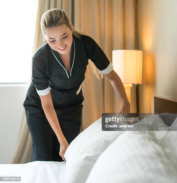 ama de llaves haciendo la cama en un hotel - criada fotografías e imágenes de stock