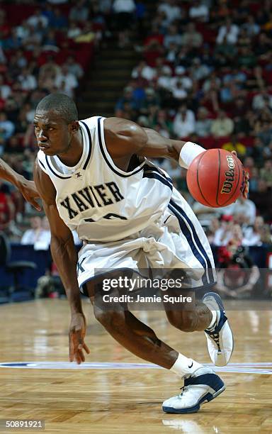 Romain Sato of the Xavier Muskateers moves the ball during the first round game of the NCAA Men's Basketball Tournament gainst the Louisville...