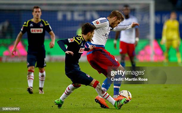 Aaron Hunt of Hamburg and Filip Mladenovic of Koeln battle for the ball during the Bundesliga match between Hamburger SV and 1. FC Koeln at...