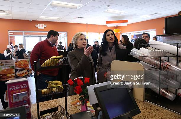Democratic presidential candidate former Secretary of State Hillary Clinton and aide Huma Abedin prepare to order food at a Dunkin Donuts during on...