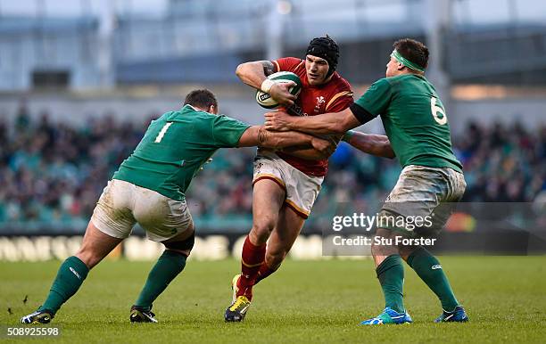 Tom James of Wales is tackled by Jack McGrath and CJ Stander of Ireland during the RBS Six Nations match between Ireland and Wales at the Aviva...