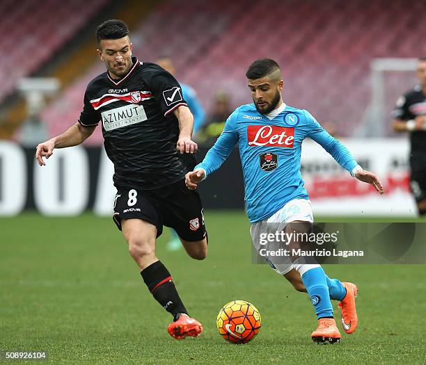 Lorenzo Insigne of Napoli competes for the ball with Raffaele Bianco of Carpi during the Serie A match between SSC Napoli and Carpi FC at Stadio San...