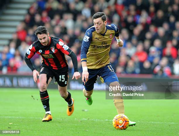 Mesut Ozil of Arsenal takes on Adam Smith of Bournemouth during the Barclays Premier League match between AFC Bournemouth and Arsenal at The Vitality...