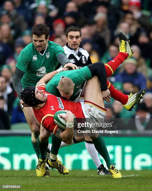 Tom James of Wales is tackled by Keith Earls and Jared Payne of Ireland during the RBS Six Nations match between Ireland and Wales at the Aviva...