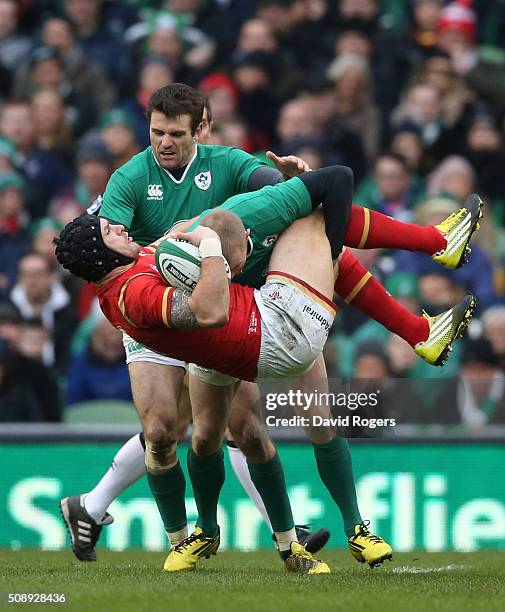 Tom James of Wales is tackled by Keith Earls and Jared Payne of Ireland during the RBS Six Nations match between Ireland and Wales at the Aviva...