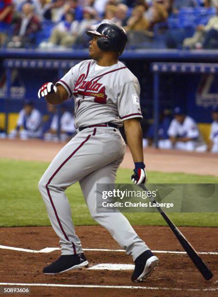 Andruw Jones of the Atlanta Braves watches his two-run home run leave the park against the Montreal Expos May 24, 2004 at Olympic Stadium in...