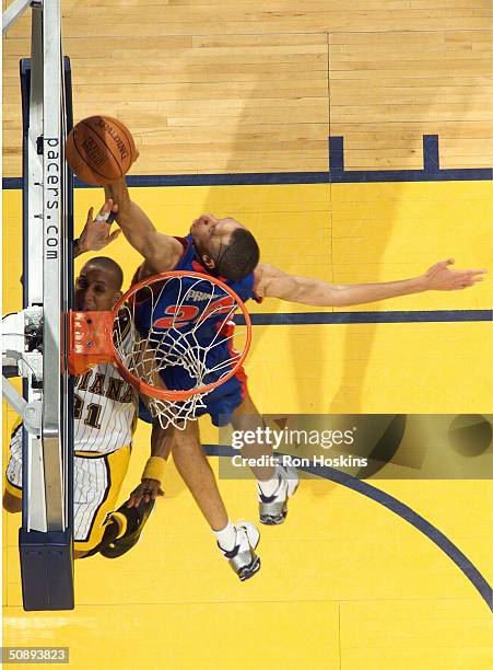 Tayshaun Prince of the Detroit Pistons blocks a shot attempt by Reggie Miller of the Indiana Pacers in the final minutes of the 4th quarter to help...