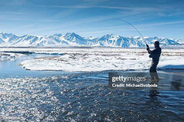 silhouette fisherman on the owens river in winter - trout fishing stock pictures, royalty-free photos & images