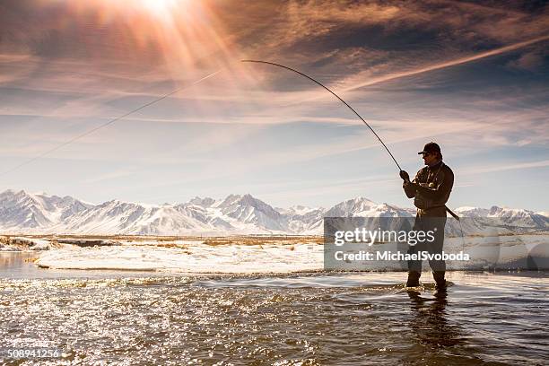 silhouette fisherman on the owens river in winter - mammoth lakes stock pictures, royalty-free photos & images