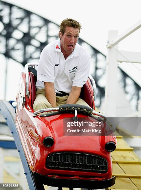 Justin Harrison of the Wallabies rides the Wild Mouse rollercoaster with the Sydney Harbour Bridge as a backdrop after the announcement of the 2004...