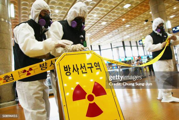 South Korean radiologists take part in an exercise in dealing with a possible radioactive terror attack at the Kimpo airport, on May 25, 2004 in...