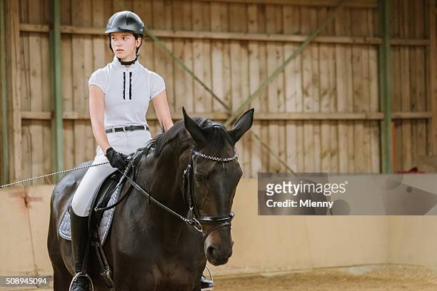 dressage riding teenage girl equestrian hall - dressage stock pictures, royalty-free photos & images