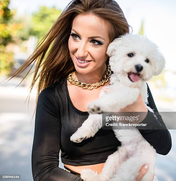 woman embracing her dog on the street - yorkshireterriër stockfoto's en -beelden