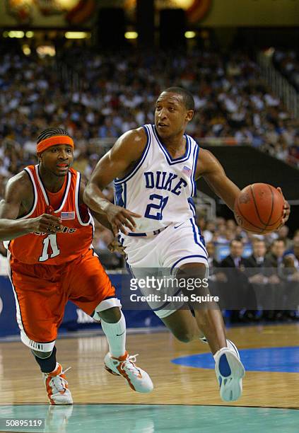 Chris Duhon of the Duke Blue Devils drives by Dee Brown of the Illinois Fighting Illini during the Sweet 16 game of the NCAA Division I Men's...