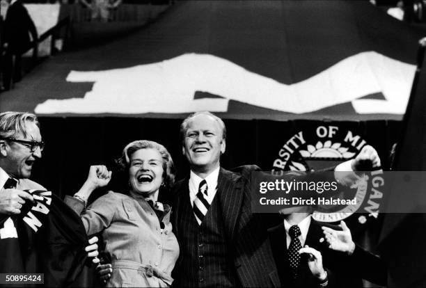 First Lady Betty Ford and American President Gerald Ford cheer at a rally held on the University of Michigan campus during Ford's re-election...