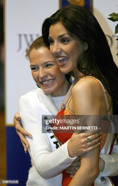 Miss Italy Laia Manetti and Mis Greece Valia Kakouti pose to photographers during an interview in Quito 25 May 2004. The Miss Universe 2004 contest...