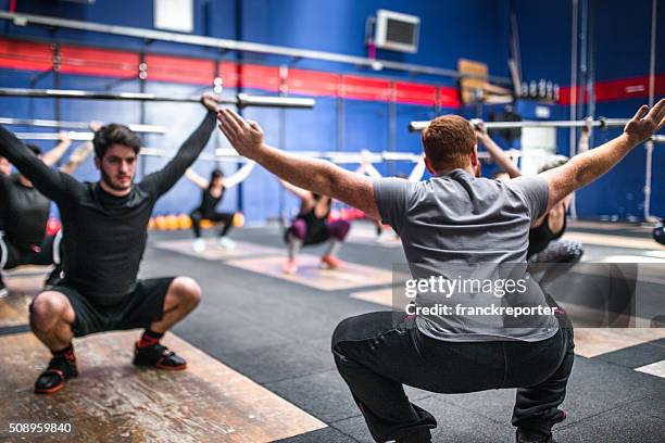 weightlifting class togetherness - snatch weightlifting stock pictures, royalty-free photos & images