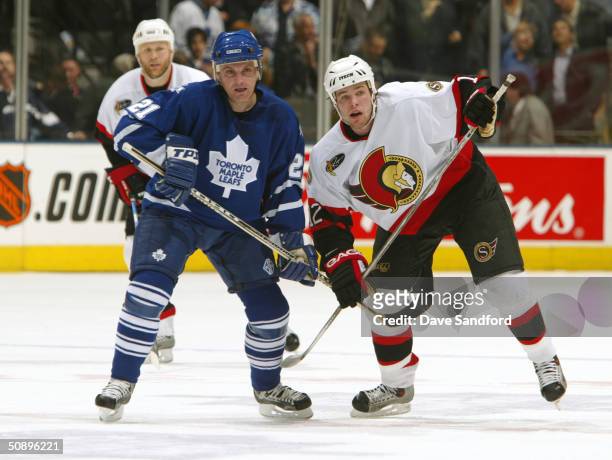 Center Robert Reichel of the Toronto Maple Leafs and center Mike Fisher of the Ottawa Senators jostle for position during game seven of the eastern...