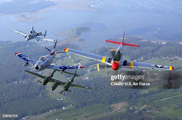 In this handout image provided by the U.S. Air Force, four generations of Air Force fighters take part in the Heritage Flight as they fly over over...