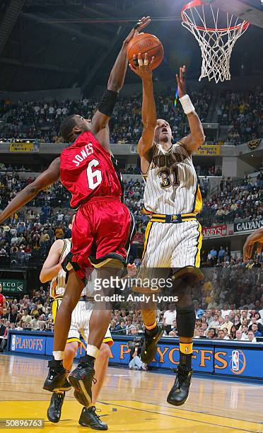Reggie Miller of the Indiana Pacers shoots a layup past Eddie Jones of the Miami Heat in Game 5 of the Eastern Conference Semifinals during the 2004...