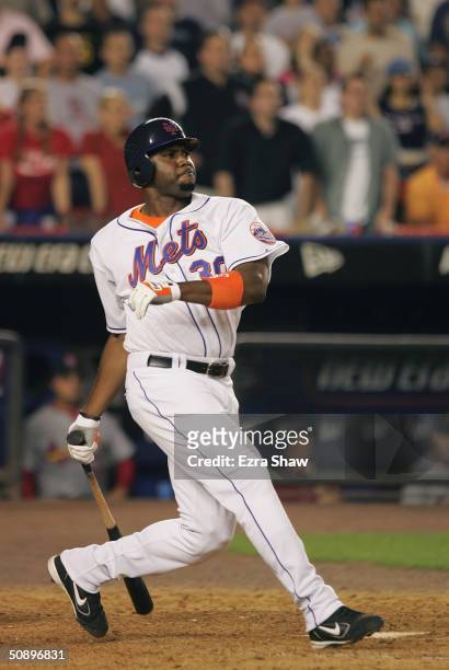 Cliff Floyd of the New York Mets hits the game-winning single in the bottom of the ninth inning which scored Karim Garcia to defeat the St. Louis...