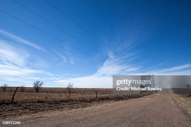 rural road with barbed wire fence - amarillo texas stock pictures, royalty-free photos & images