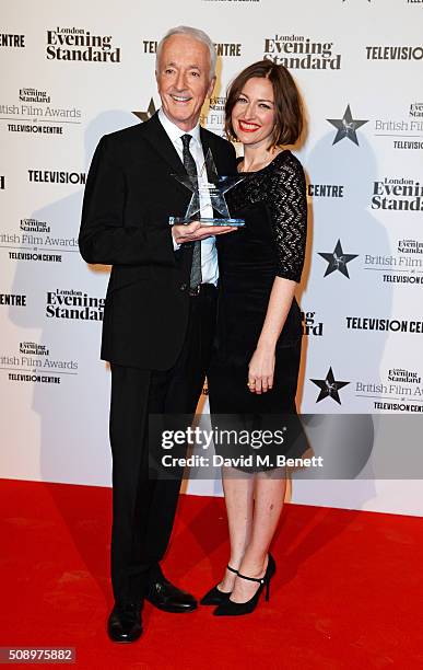 Anthony Daniels, accepting the Blockbuster of the Year award for "Star Wars: The Force Awakens", and presenter Kelly Macdonald pose in front of the...