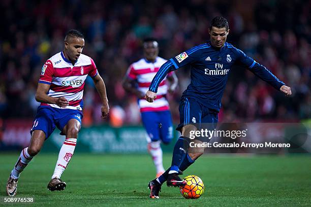 Cristiano Ronaldo of Real Madrid CF competes for the ball with Youssef El-Arabi of Granada CF during the La Liga match between Granada CF and Real...