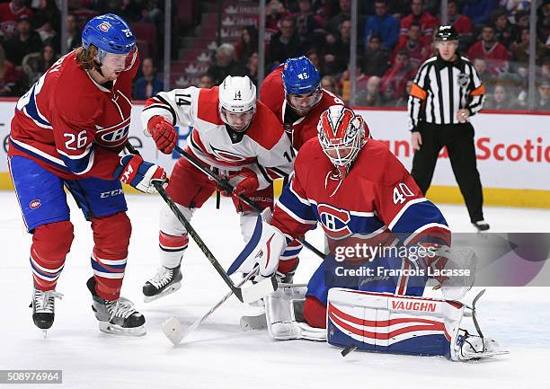 Ben Scrivens of the Montreal Canadiens blocks the shot by the Carolina Hurricanes in the NHL game at the Bell Centre on February 7, 2016 in Montreal,...