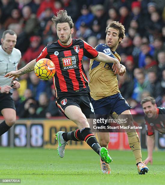 Mathieu Flamini of Arsenal challenges Harry Arter of Bournemouth during the Barclays Premier League match between AFC Bournemouth and Arsenal at The...