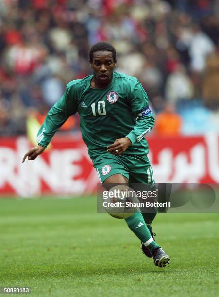 Jay Jay Okocha of Nigeria runs with the ball during the African Nations Cup 2004 Semi-Final match between Tunisia and Nigeria held at the Olympic...