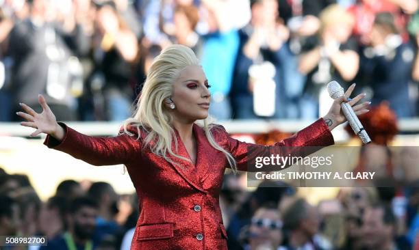 Lady Gaga sings the American National Anthem prior to the start of Super Bowl 50 between the Carolina Panthers and the Denver Broncos at Levi's...