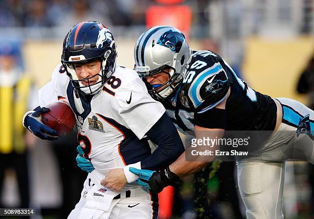 Peyton Manning of the Denver Broncos is tackled by Luke Kuechly of the Carolina Panthers in the first quarter during Super Bowl 50 at Levi's Stadium...