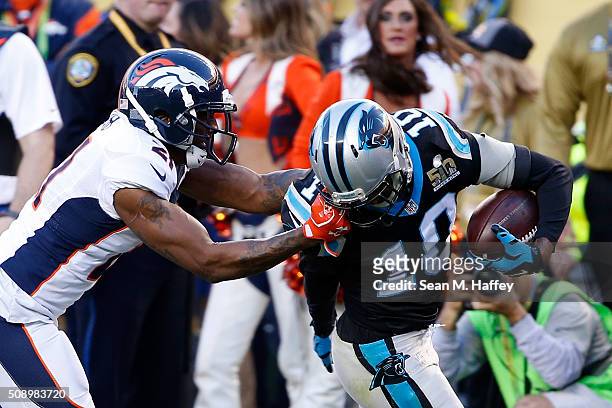 Aqib Talib of the Denver Broncos tackles Corey Brown of the Carolina Panthers by his facemask during Super Bowl 50 at Levi's Stadium on February 7,...