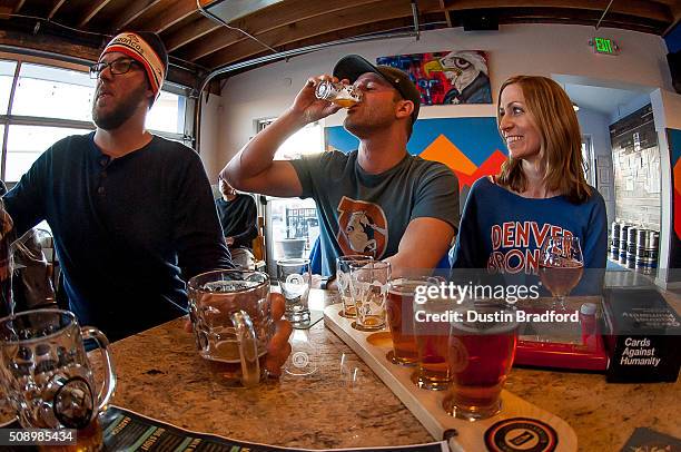 Denver Broncos fans drink beer as they watch Super Bowl 50 at Declaration Brewing Companyon February 7, 2016 in Denver, Colorado.