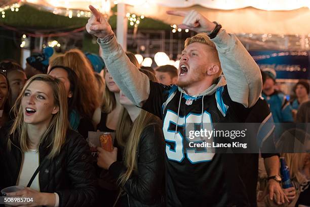 Fans of the Carolina Panthers cheer on their team against the Denver Broncos while watching Super Bowl 50 on February 7, 2016 at Rooftop 210 in the...