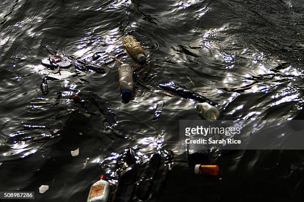 Garbage floats in the Flint River on February 7, 2016 in Flint, Michigan. Months ago the city told citizens they could use tap water if they boiled...