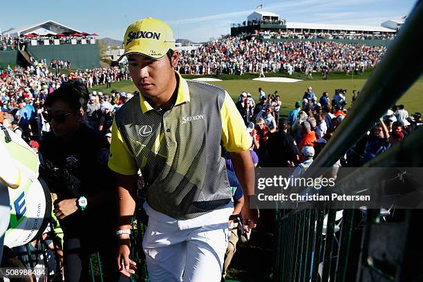 Hideki Matsuyama of Japan walks off the 18th green following regulation during the final round of the Waste Management Phoenix Open at TPC Scottsdale...