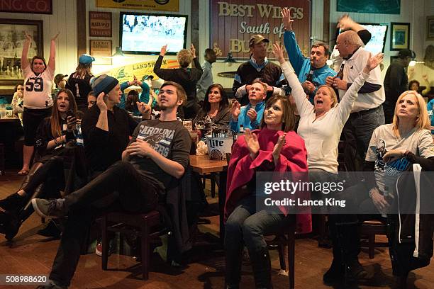 Fans of the Carolina Panthers cheer on their team against the Denver Broncos while watching Super Bowl 50 on February 7, 2016 at Wild Wing Cafe in...