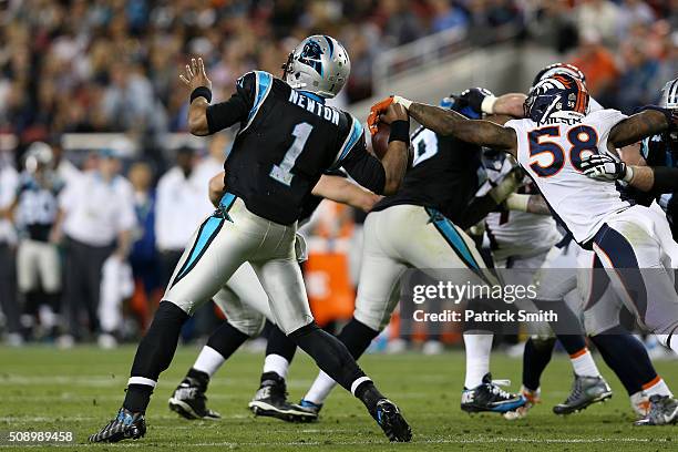 Von Miller of the Denver Broncos strips the ball from Cam Newton of the Carolina Panthers in the fourth quarter during Super Bowl 50 at Levi's...