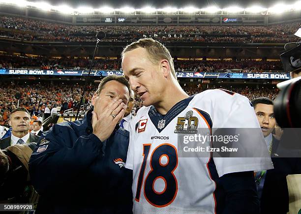 Head coach Gary Kubiak talks with Peyton Manning of the Denver Broncos defeating the Carolina Panthers during Super Bowl 50 at Levi's Stadium on...