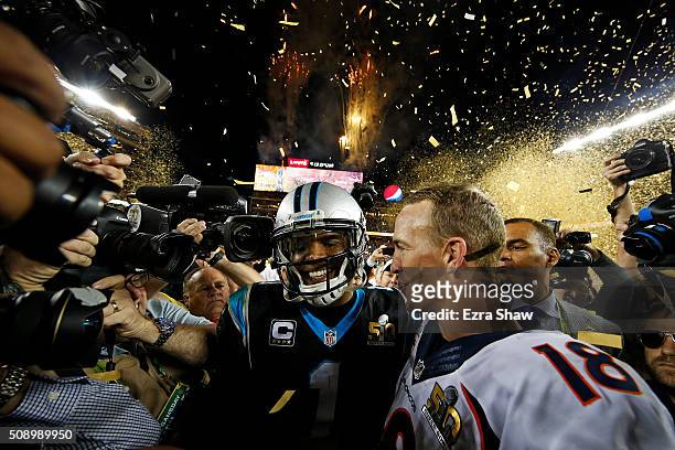 Cam Newton of the Carolina Panthers and Peyton Manning of the Denver Broncos speak on the field after Super Bowl 50 at Levi's Stadium on February 7,...