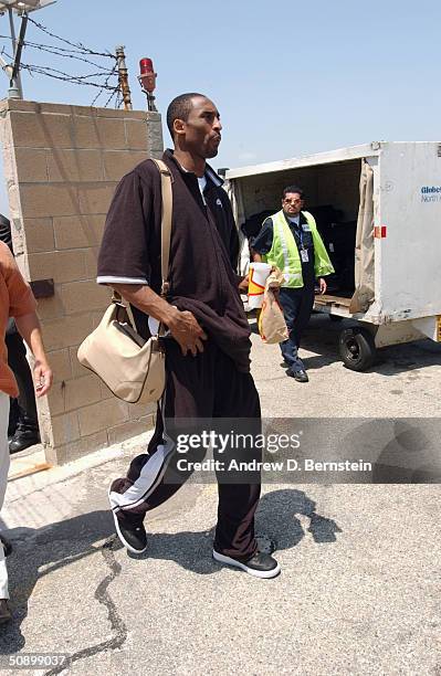 Kobe Bryant of the Los Angeles Lakers walks to the plane before Game one of the Western Conference Finals during the 2004 NBA Playoffs on May 21,...