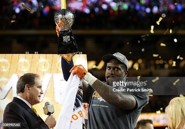 Von Miller of the Denver Broncos holds up the Vince Lombardi Trophy after defeating the Carolina Panthers during Super Bowl 50 at Levi's Stadium on...